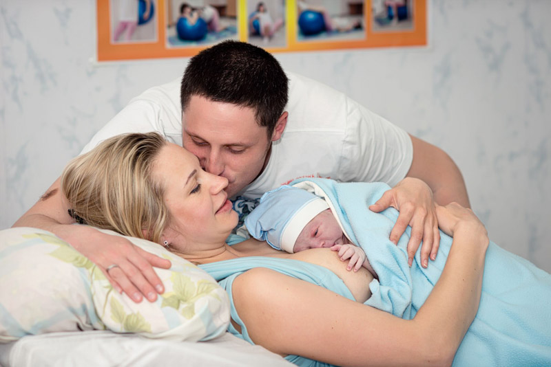 home birth couple with baby
